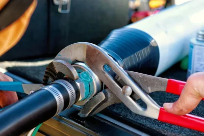 Technician tightening an industrial pipe connection in Gainesville