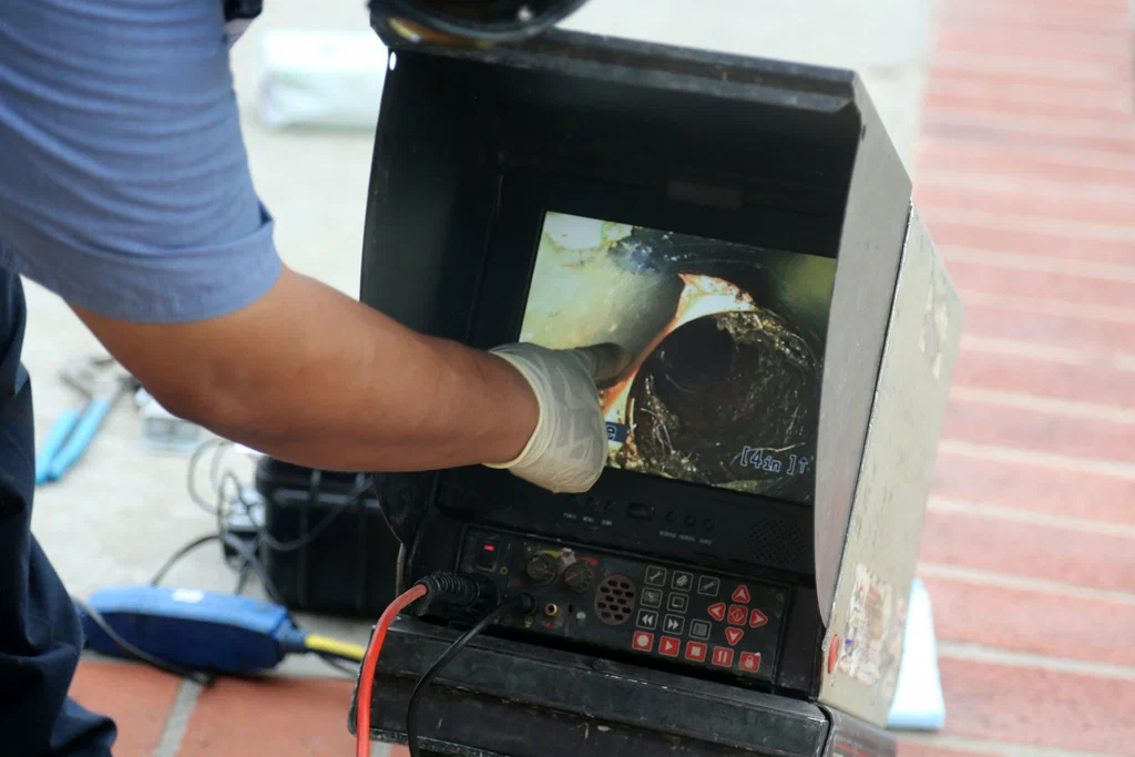 Technician viewing a drain inspection camera in Gainesville
